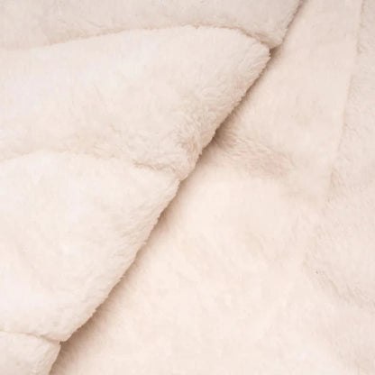 A close-up of the Rumpl Sherpa Puffy blanket in Deepwater color, showing its soft texture and folded layers.