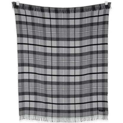 A charcoal and graphite plaid blanket from the Sackcloth & Ashes Folk Collection hangs on a clothesline with fringes visible.