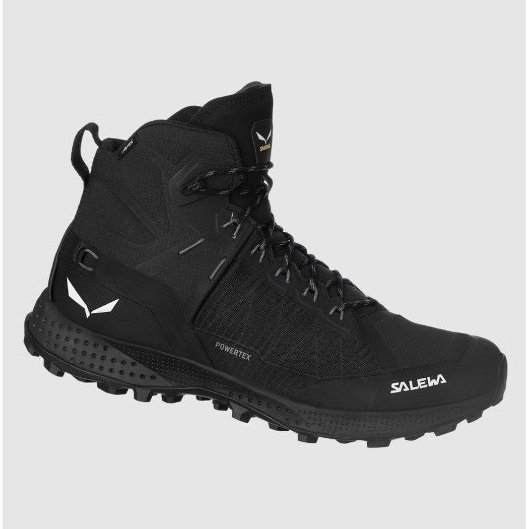 A side view of the black Salewa Women's Pedroc Pro Powertex Mid Boot with a rugged outsole against a plain background.
