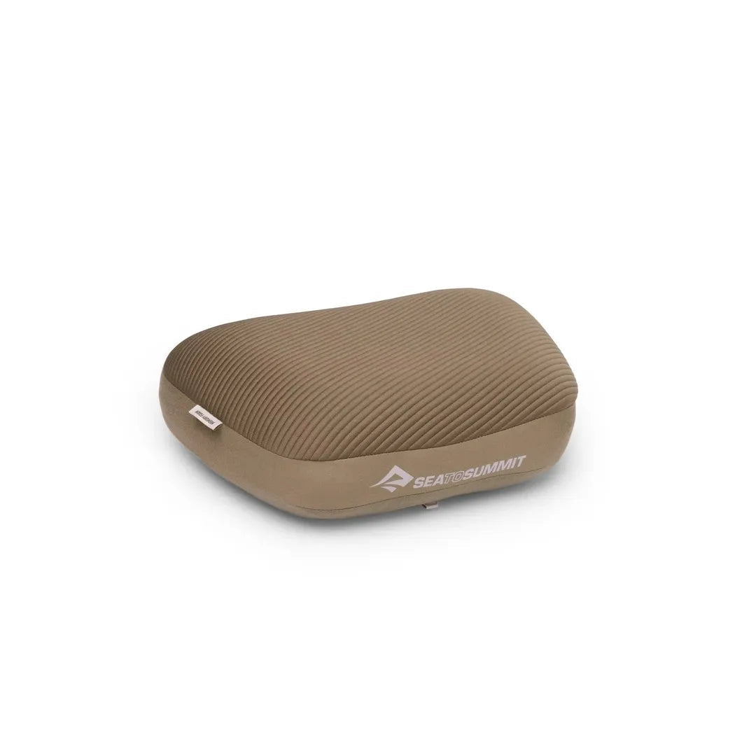 A side view of the Sea To Summit Aeros Premium Pillow in Burnt Olive showing the ribbed texture against a white background.