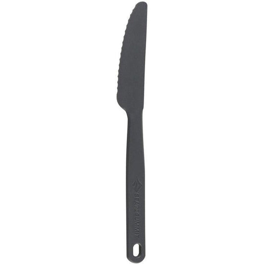 A side view of the Sea To Summit Camp Cutlery - Knife in Charcoal showing the serrated blade and handle with a hole against a white background.