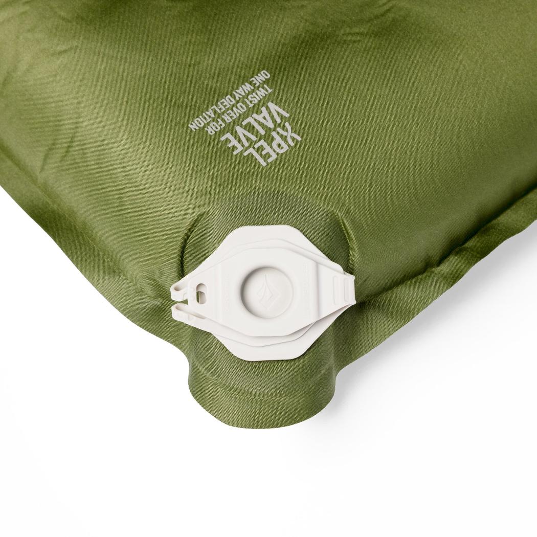 A close-up of the Sea To Summit Camp Plus Self Inflating Mat in Regular Green showing the valve and text on the top.