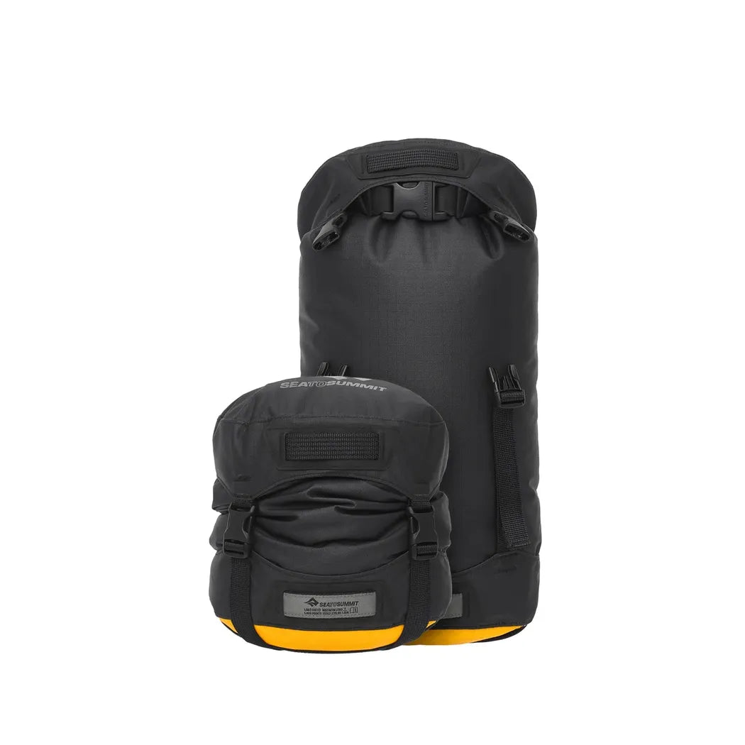 Two Jet Black Sea To Summit Evac Heavy Duty Compression Dry Bags sit against a white background, one larger than the other.