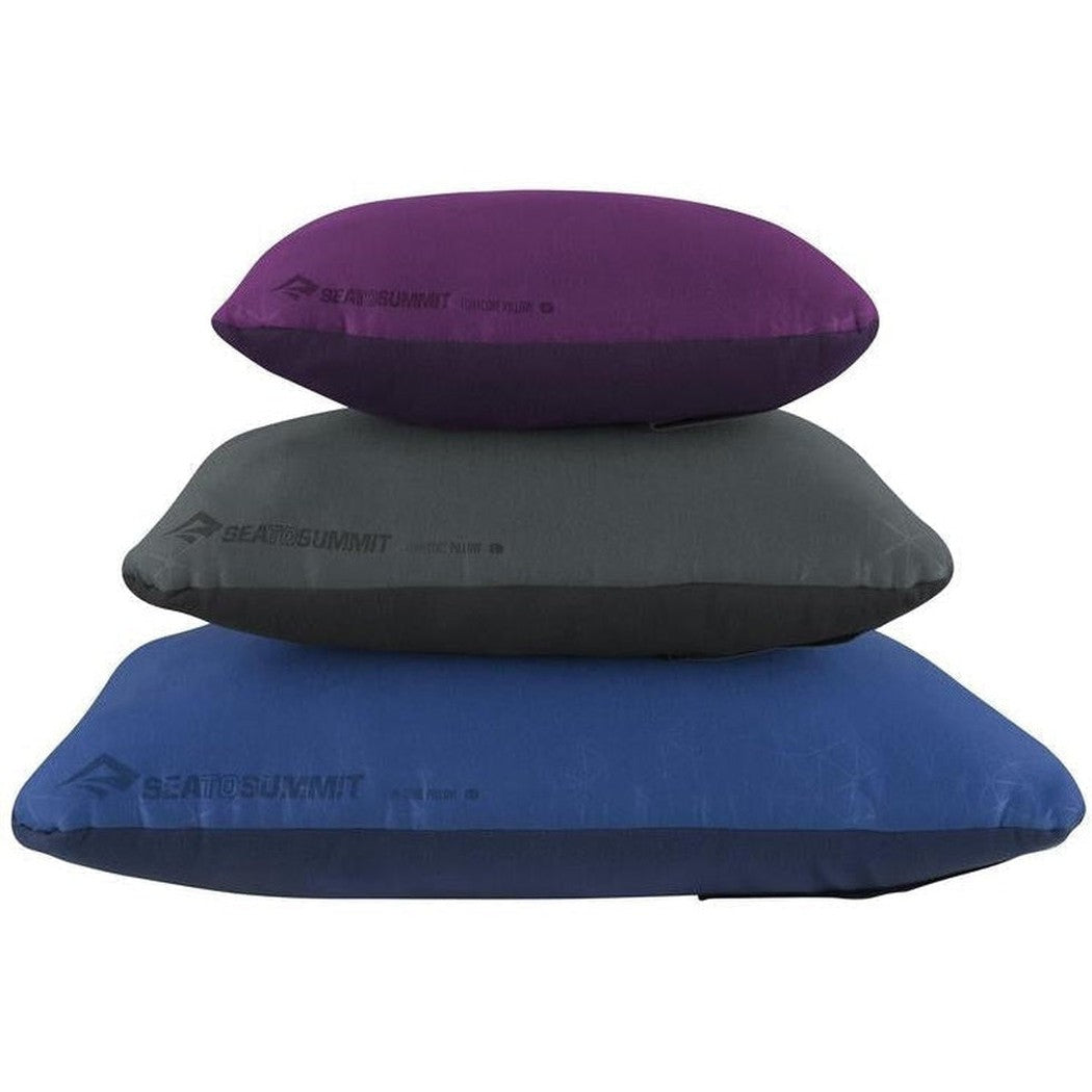 Three Sea To Summit FoamCore Pillows stacked vertically in grey, charcoal and blue colors against a white background.