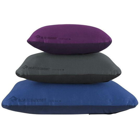 Three Sea To Summit FoamCore Pillows stacked vertically in grey, charcoal and blue colors against a white background.