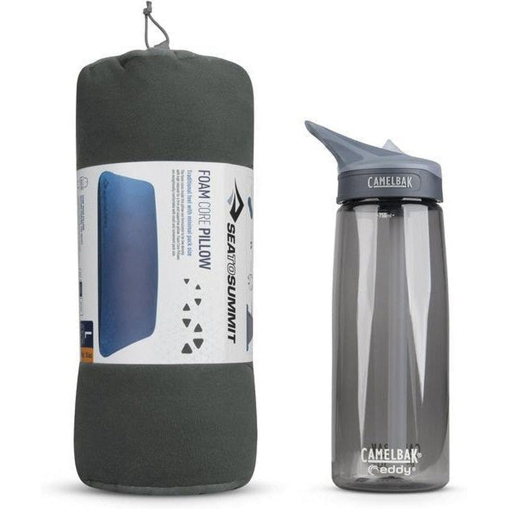 A grey Sea To Summit FoamCore Pillow next to a CamelBak Eddy water bottle on a white background.