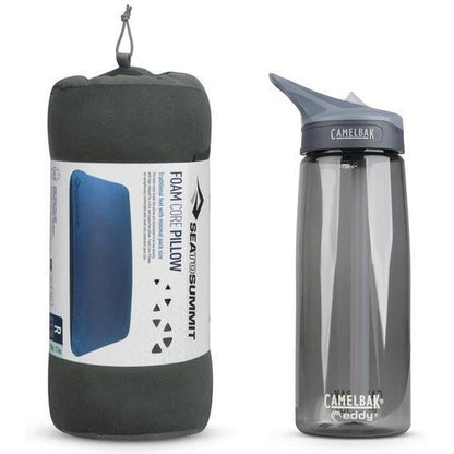 A grey Sea To Summit FoamCore Pillow in its stuff sack next to a CamelBak water bottle.