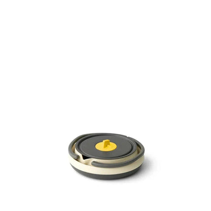 A top-down view of the Sea To Summit Frontier UL Collapsible Kettle - 1.1L with a charcoal/gray lid and yellow knob, set against a plain white background.