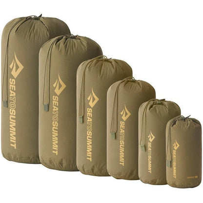 Six olive green Sea To Summit lightweight stuff sacks in various sizes lined up against a white background.