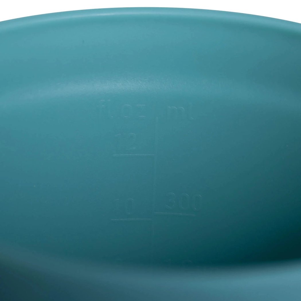 A close-up of the Sea To Summit Passage Insulated Mug - 16oz in Aqua Sea Blue showing the measurement markings inside.