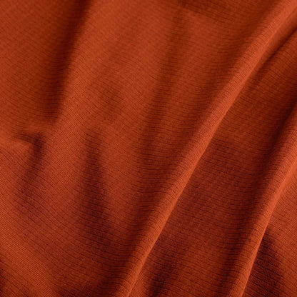The Sea To Summit Reactor Fleeceweight Liner - Regular in a warm rust color shows the soft, textured fabric with natural folds and creases.