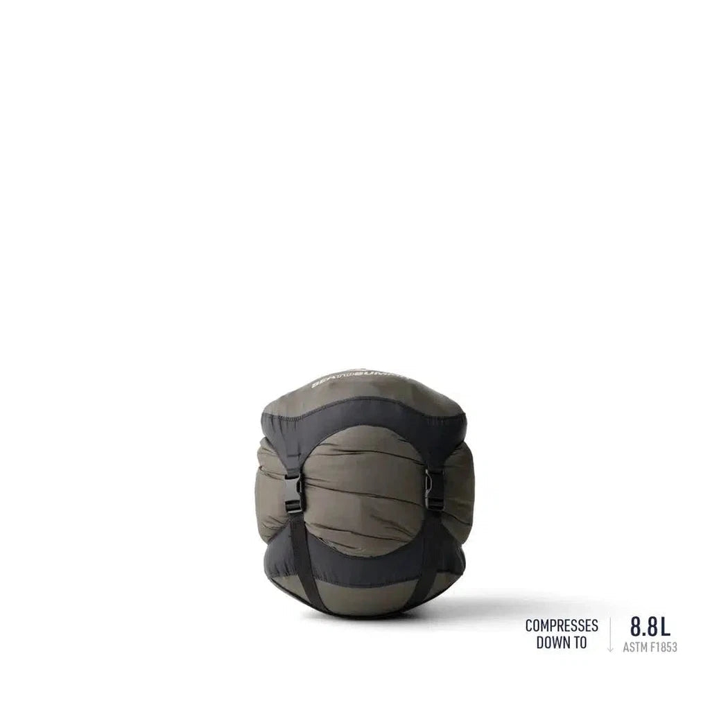 A compact Sea To Summit Trek Down Sleeping Bag Unisex 30F | -1C in Snorkel Blue sits against a white background with compression straps visible.