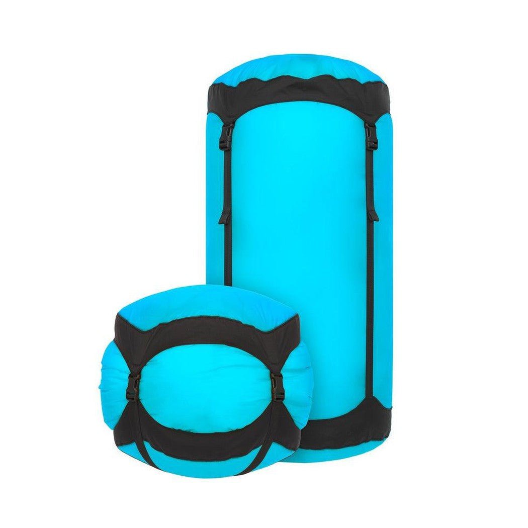 Side view of the Sea To Summit Ultra-Sil Compression Sack in Atoll Blue showing the black compression straps against a white background.