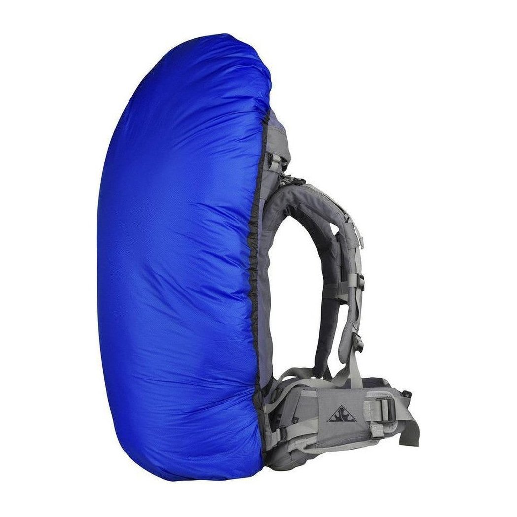Side view of the Sea To Summit Ultra-Sil Pack Cover in Blue showing the backpack straps and a white background.