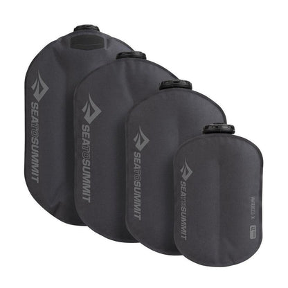 Four Sea To Summit Watercell X hydration bladders in charcoal color, shown from front angle against white background.