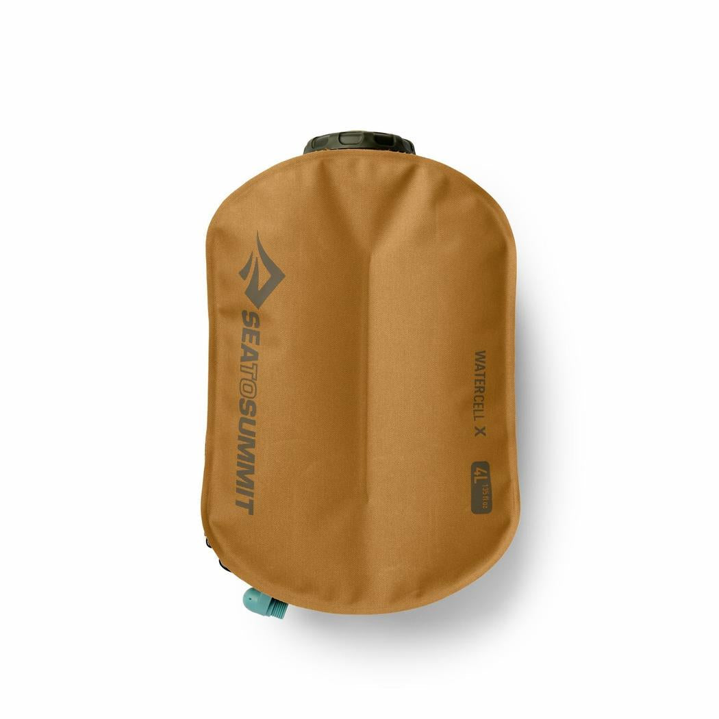 A top-down view of the Sea To Summit Watercell X 4L hydration reservoir in tan, showing the brand logo and a teal valve against a white background.