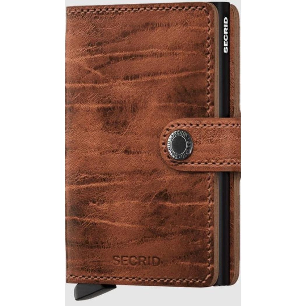 A front view of the SECRID Mini Wallet - Dutch Martin in Whiskey showing the snap closure and brand name embossed on the front.