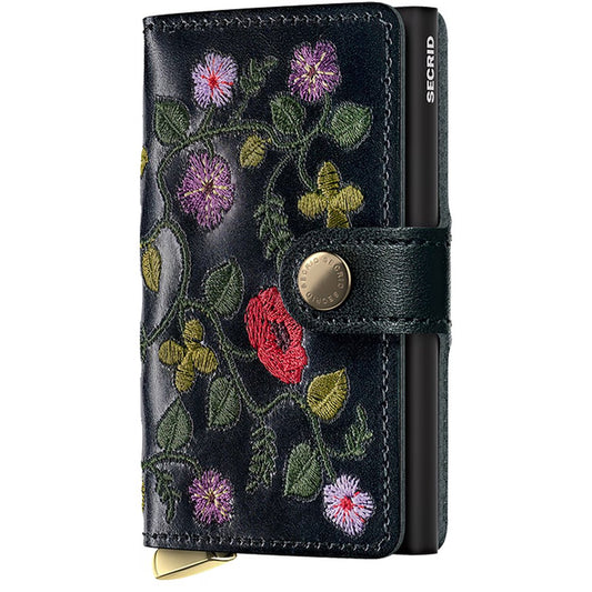 A front view of the SECRID Mini Wallet - Stitch + in Floral Black showing the floral embroidery and metal snap closure.