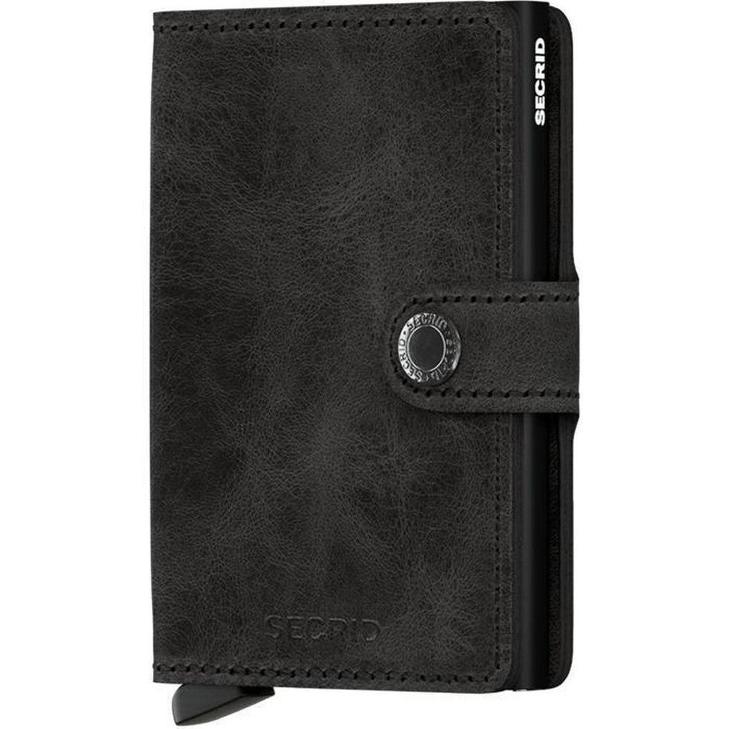 A front view of the SECRID Mini Wallet / Vintage in Black showing the metal snap closure and brand name embossed on the front.