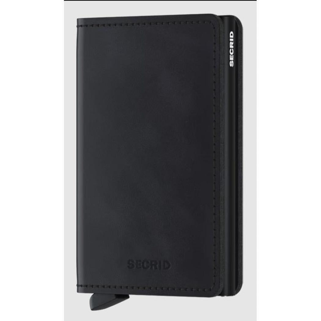 A front view of the SECRID Slim Wallet - Vintage in Black showing the brand name embossed on the front and a pull tab at the bottom.
