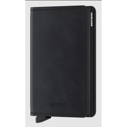 A front view of the SECRID Slim Wallet - Vintage in Black showing the brand name embossed on the front and a pull tab at the bottom.