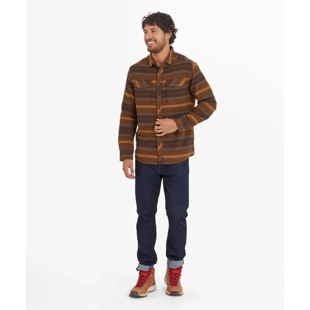 A man wearing the Sherpa Adventure Gear Men's Choejor Short in Cappuccino stands against a white background.