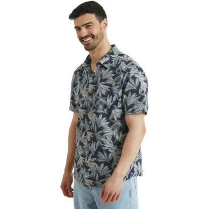 Side view of the Sherpa Adventure Gear Men's Havai Short Sleeve Shirt in Rathee Blue on a model against a white background.
