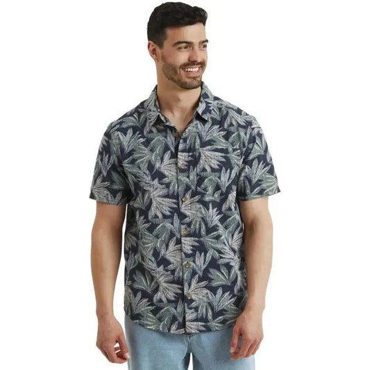 A front view of the Sherpa Adventure Gear Men's Havai Short Sleeve Shirt in Rathee Blue on a model against a white background.