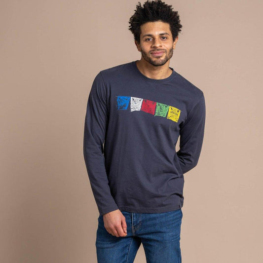 A man wearing the Sherpa Adventure Gear Men's Tarcho Long Sleeve Tee in Rathee stands against a neutral background.
