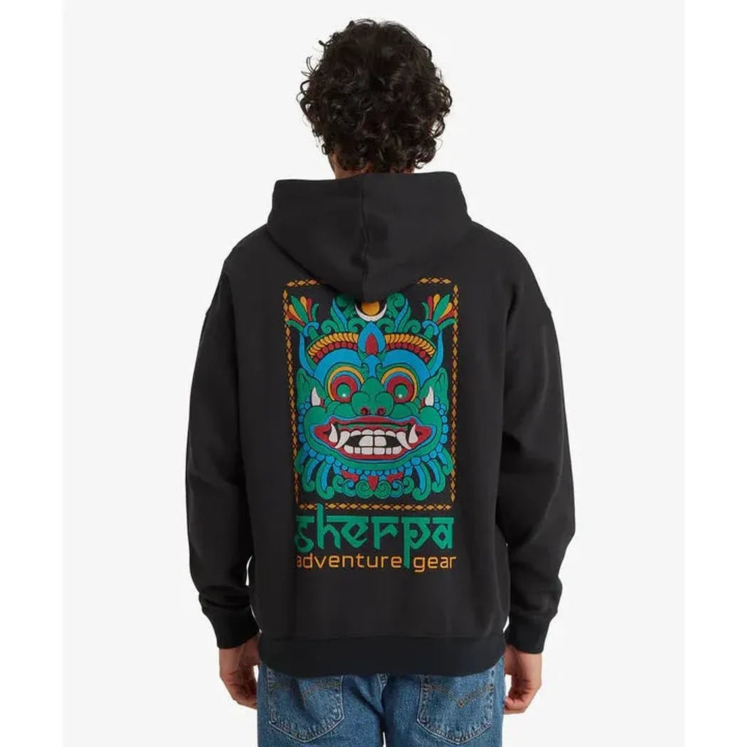 Back view of the Sherpa Adventure Gear Men's Tarcho Mask Hoodie in Black on a model wearing blue jeans.