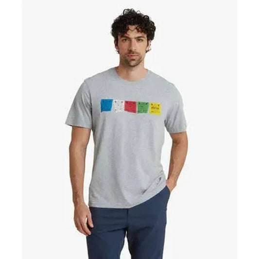 A man wearing the Sherpa Adventure Gear Men's Tarcho Tee in Heather Grey stands against a plain white background.