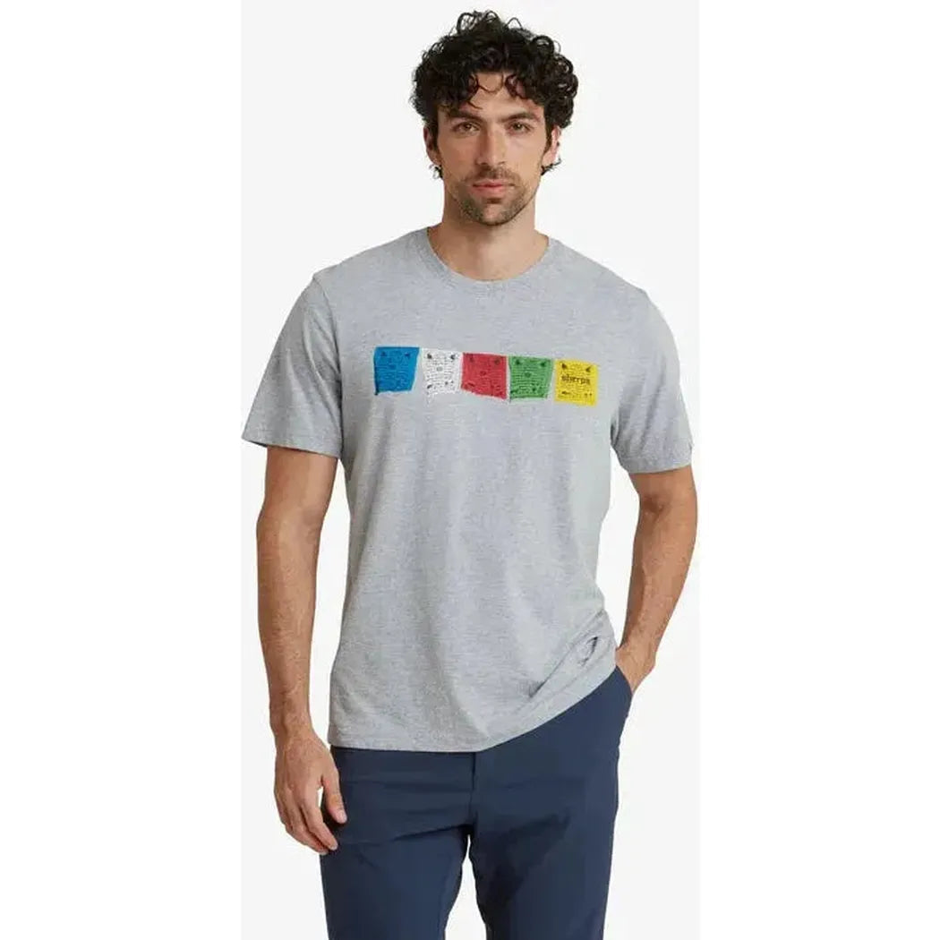 A man wearing the Sherpa Adventure Gear Sample - Men's Tarcho Tee in Heather Grey stands against a plain white background.
