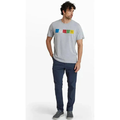 A man wearing the Sherpa Adventure Gear Sample - Men's Tarcho Tee in Heather Grey stands against a white background.