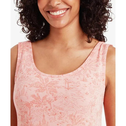 A model wearing the Sherpa Adventure Gear Women's Neha Long Tank Dress in Rose Gold smiles at the camera with a white background.