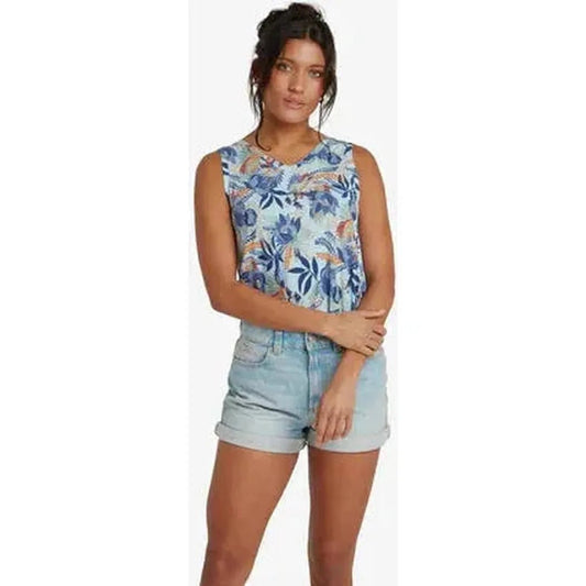 A model wearing the Sherpa Adventure Gear Women's Neha V-Neck Tank in Seaport Blue Peacock stands against a plain white background.