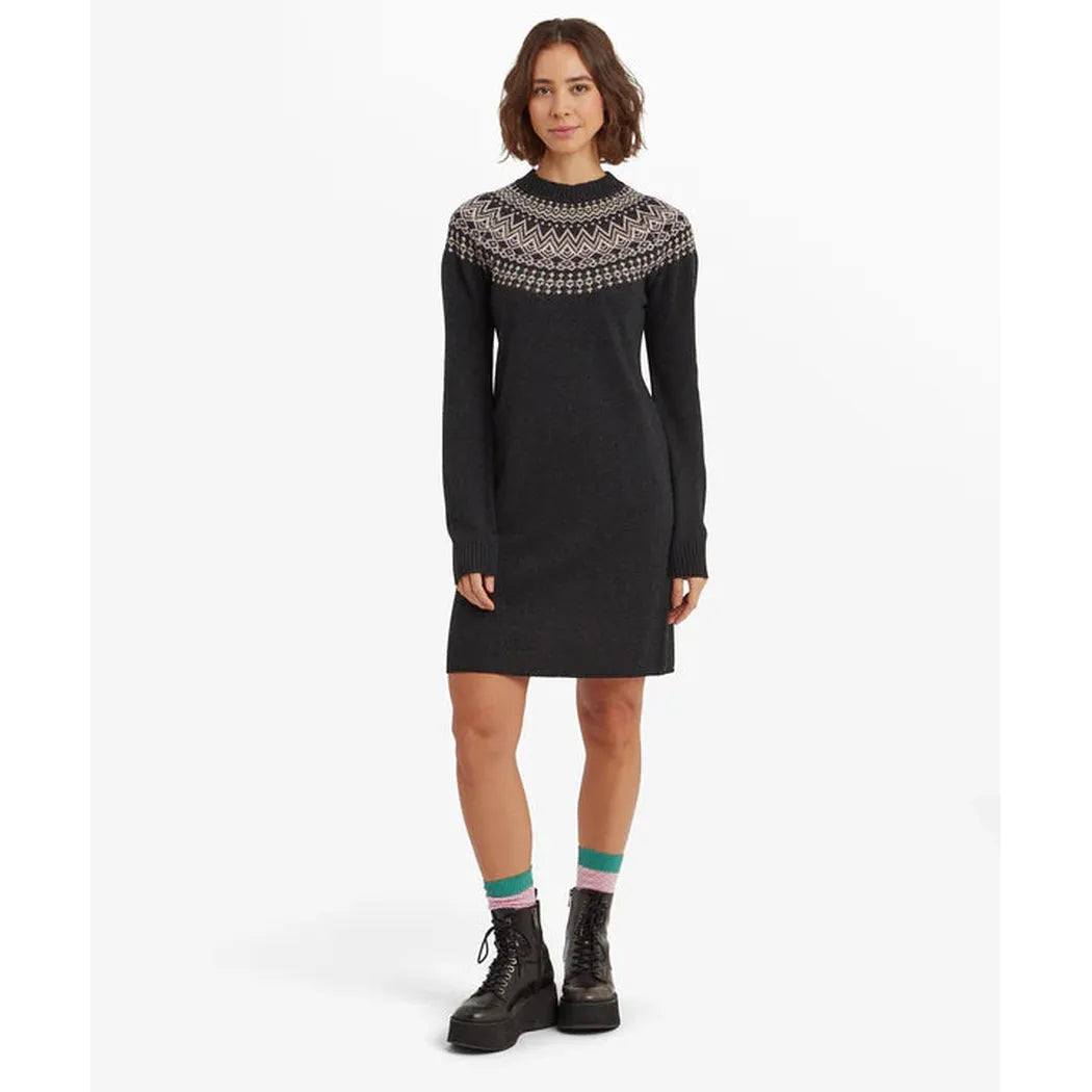 A model wearing the Sherpa Adventure Gear Women's Pamu Dress in Black stands against a white background.