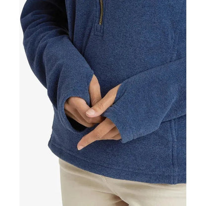 A close-up of the Sherpa Adventure Gear Women's Rolpa Eco Pullover Zip in Rathee Blue, showing the half-zip and model's hands against a plain white background.