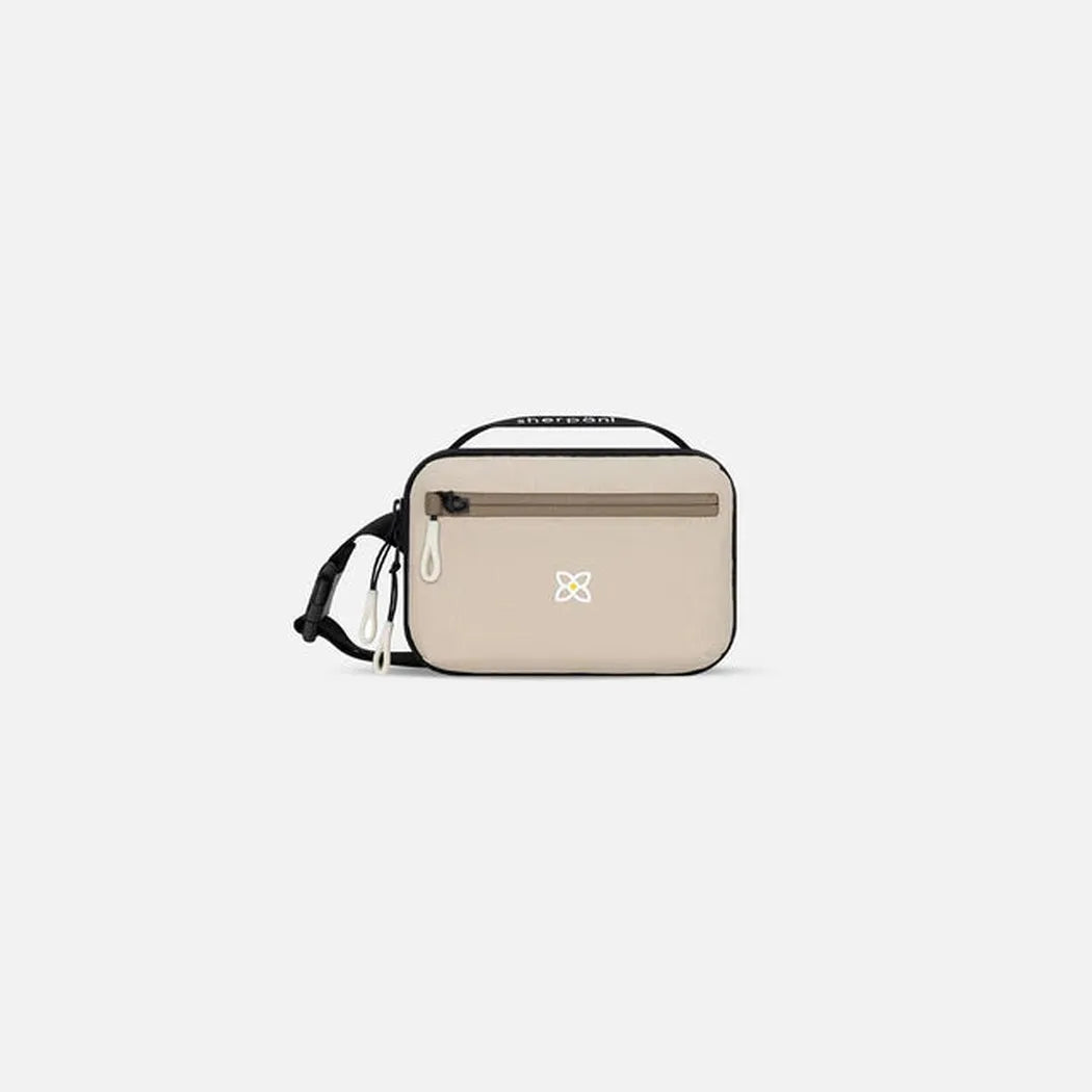 A front view of the Sherpani Hyk bag in Chromatic with a zippered pocket and adjustable strap against a plain white background.