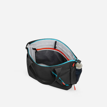 A top-down view of the Sherpani Jetsetter Tote in Chromatic showing its interior and a water bottle attached to the side against a white background.