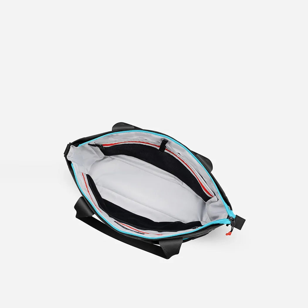 The open Sherpani Jetsetter Tote in Chromatic shows its interior lining and straps against a plain white background.
