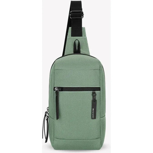 A front view of the Sherpani Metro AT in Aloe Mist showing the front zip pocket and adjustable shoulder strap against a white background.