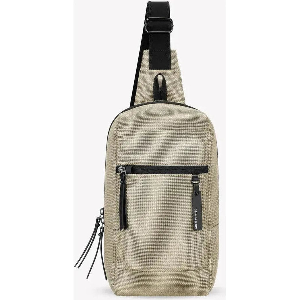 A front view of the Sherpani Metro AT in Aloe Mist showing the front zip pocket and adjustable shoulder strap against a white background.