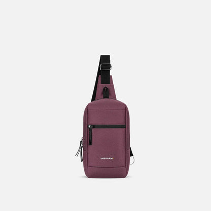 A front view of the Sherpani Metro AT bag in Aloe Mist with a black shoulder strap and front zip pocket against a white background.