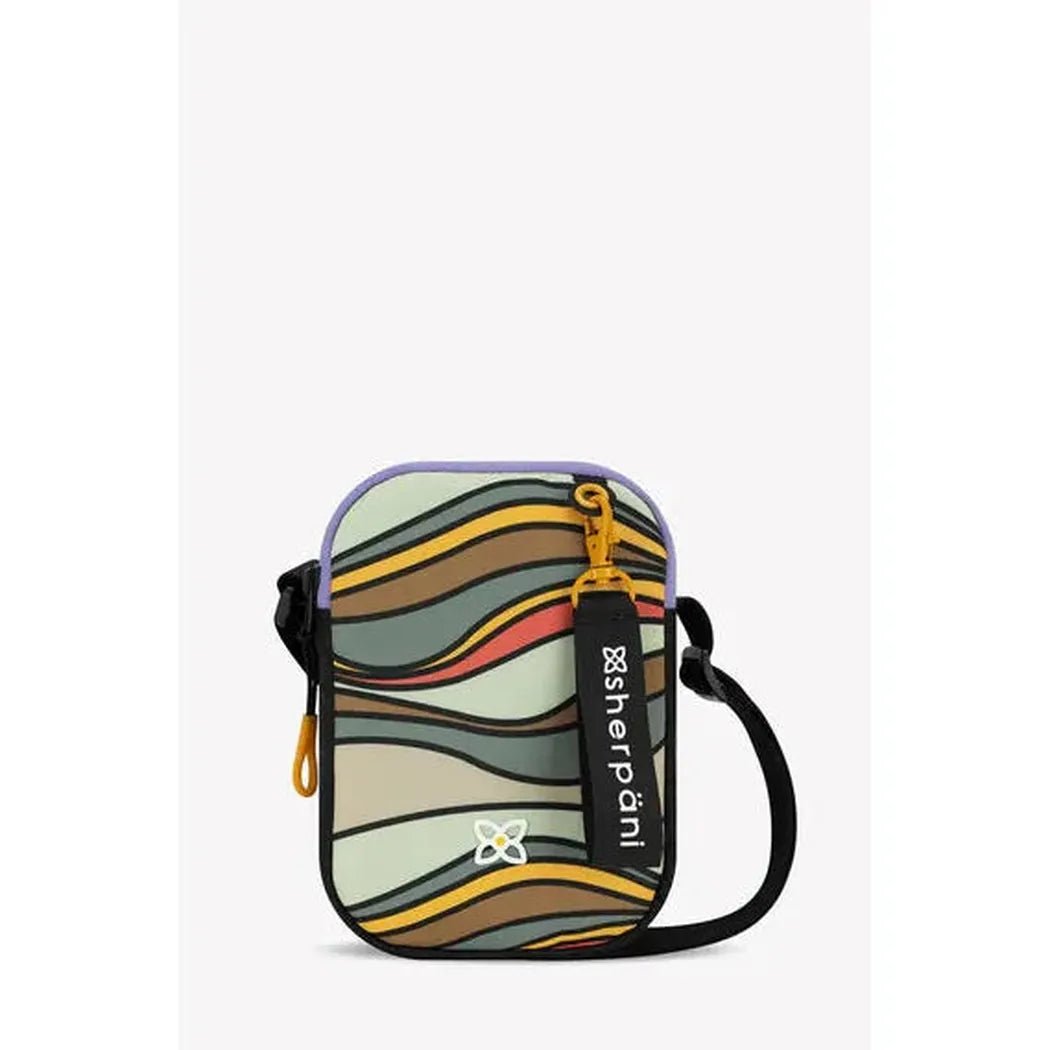 A front view of the Sherpani Rogue Chromatic crossbody bag with a colorful wave pattern, black strap, and yellow zipper pull against a plain white background.