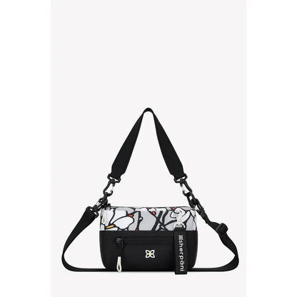 A front view of the Sherpani Skye bag in Alchemy with a black strap and white floral pattern against a plain white background.