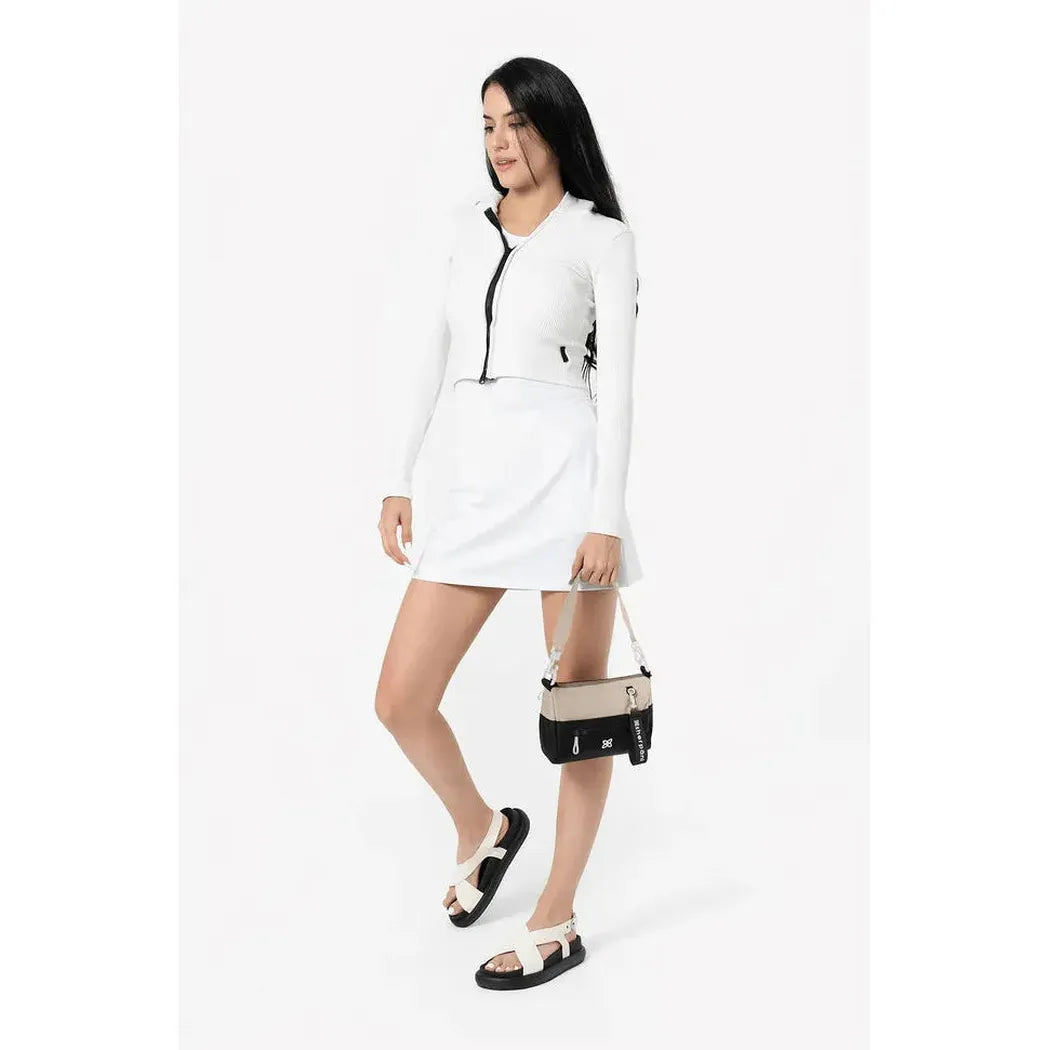 A model wearing the Sherpani Skye Alchemy bag in a side view against a white background.