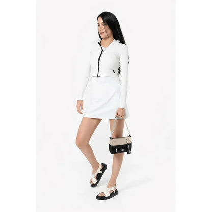 A model wearing the Sherpani Skye Alchemy bag in a side view against a white background.