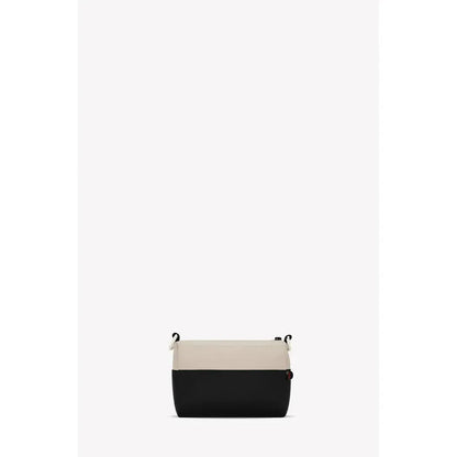 A front view of the Sherpani Skye bag in Alchemy color with a black bottom and light top, hanging against a plain white background.