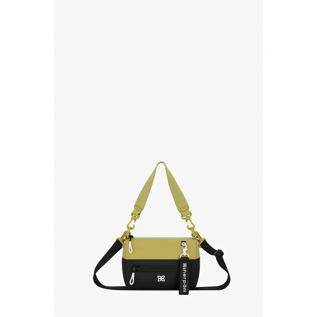 A front view of the Sherpani Skye bag in Alchemy color with a black bottom section and yellow top, showing the shoulder strap and zipper details against a white background.