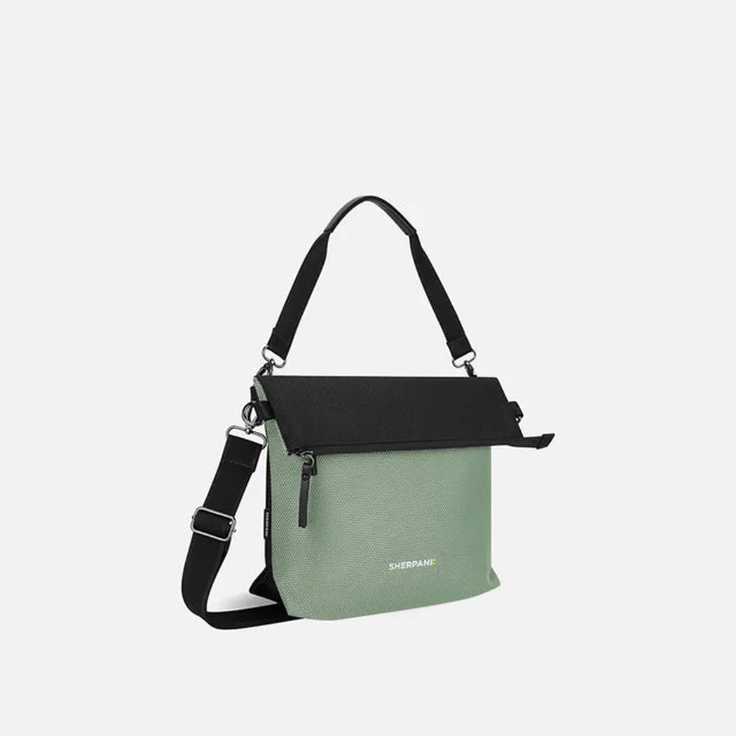 Side view of the Sherpani Vale AT bag in Aloe Mist showing the shoulder strap and front zipper against a white background.
